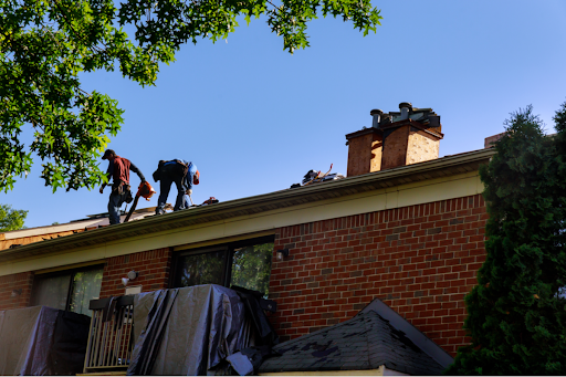 workers form 1 By 1 Roof work to repair a residential roof