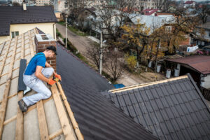 a roofing contractor working on building a metal roof